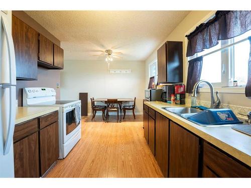 145W 300N, Raymond, AB - Indoor Photo Showing Kitchen With Double Sink