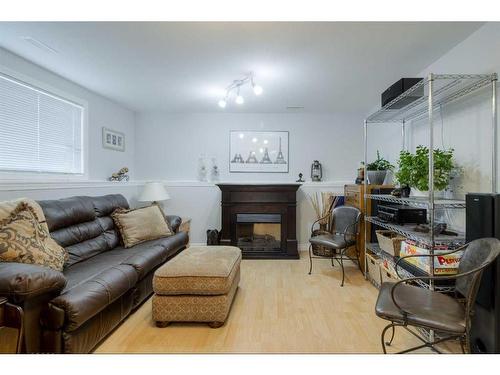 108 Mt Sundance Crescent West, Lethbridge, AB - Indoor Photo Showing Living Room With Fireplace