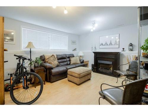 108 Mt Sundance Crescent West, Lethbridge, AB - Indoor Photo Showing Living Room With Fireplace