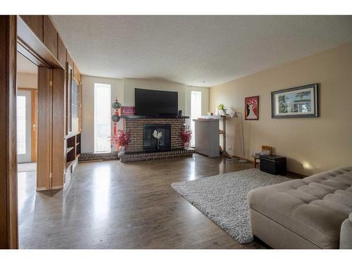 2219 20 Avenue, Coaldale, AB - Indoor Photo Showing Living Room With Fireplace