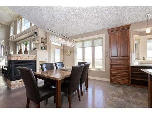 135 Stonecrest Point West, Lethbridge, AB - Indoor Photo Showing Dining Room With Fireplace