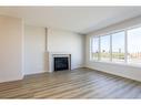 1153 Abitibi Road West, Lethbridge, AB  - Indoor Photo Showing Living Room With Fireplace 