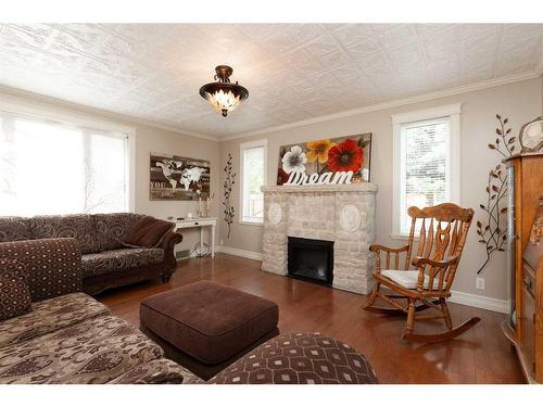 81 E 3 Avenue South, Magrath, AB - Indoor Photo Showing Living Room With Fireplace