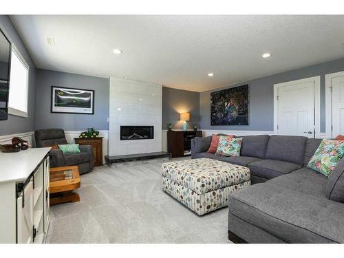 29 Pebble Creek Cove, Raymond, AB - Indoor Photo Showing Living Room With Fireplace