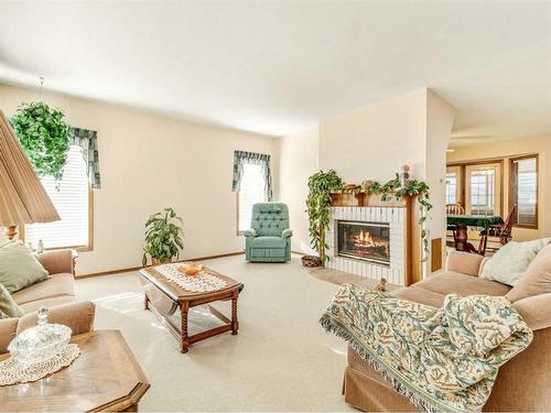 5810 46 Street, Taber, AB - Indoor Photo Showing Living Room With Fireplace