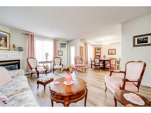 323-100 2 Avenue South, Lethbridge, AB - Indoor Photo Showing Living Room With Fireplace