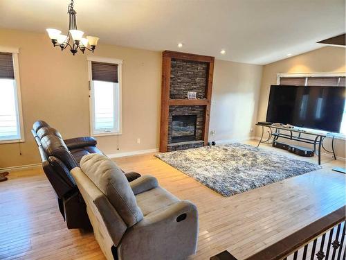 502 Centennial Avenue, Nobleford, AB - Indoor Photo Showing Living Room With Fireplace