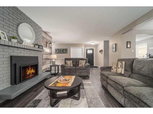 1501 Aspen Place South, Lethbridge, AB - Indoor Photo Showing Living Room With Fireplace