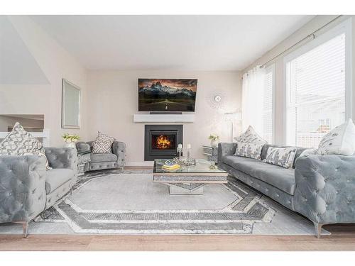 665 Aquitania Boulevard West, Lethbridge, AB - Indoor Photo Showing Living Room With Fireplace