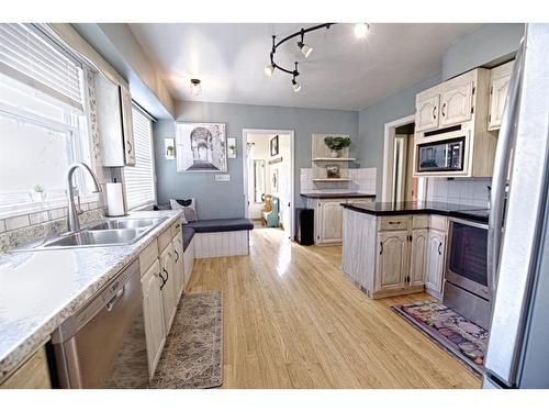 192W 100 N Avenue, Raymond, AB - Indoor Photo Showing Kitchen With Stainless Steel Kitchen With Double Sink With Upgraded Kitchen