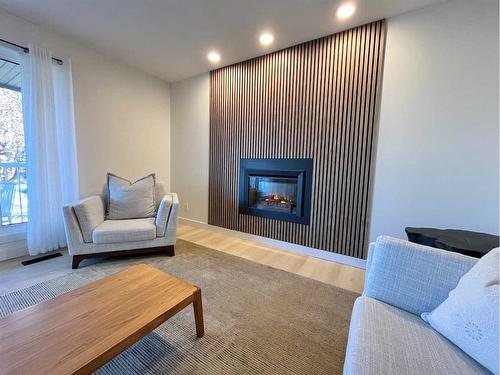 150 Oxford Road West, Lethbridge, AB - Indoor Photo Showing Living Room With Fireplace