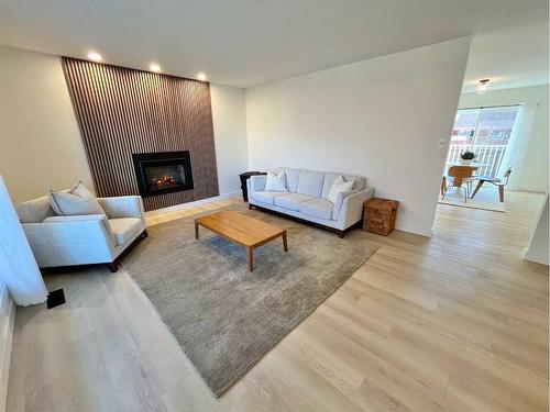 150 Oxford Road West, Lethbridge, AB - Indoor Photo Showing Living Room With Fireplace