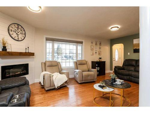 4808 51 Avenue, Taber, AB - Indoor Photo Showing Living Room With Fireplace