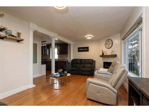 4808 51 Avenue, Taber, AB - Indoor Photo Showing Living Room With Fireplace