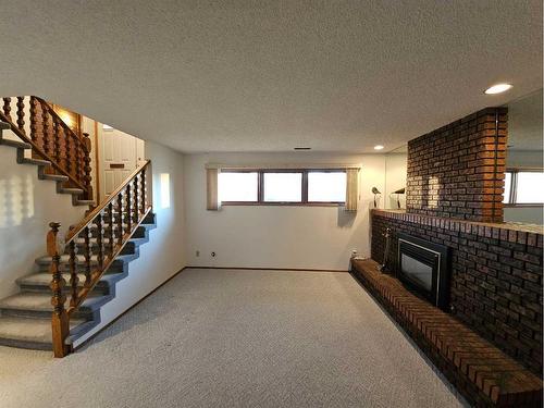 3725 Oak Drive South, Lethbridge, AB - Indoor Photo Showing Other Room With Fireplace