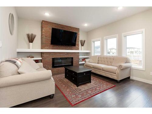 601 Bluebell Bay West, Lethbridge, AB - Indoor Photo Showing Living Room With Fireplace