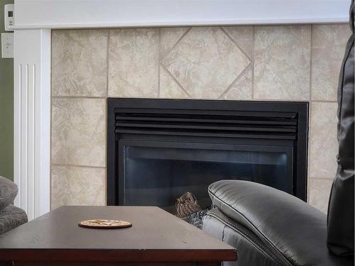 609 46 Avenue West, Claresholm, AB - Indoor Photo Showing Living Room With Fireplace