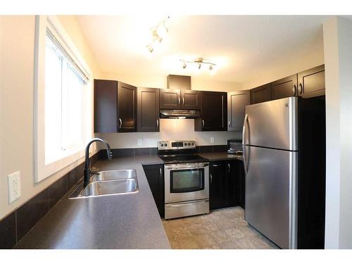 4-221 Silkstone Road West, Lethbridge, AB - Indoor Photo Showing Kitchen With Double Sink