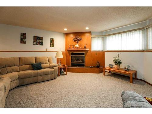 4106 Heritage Drive, Taber, AB - Indoor Photo Showing Living Room With Fireplace