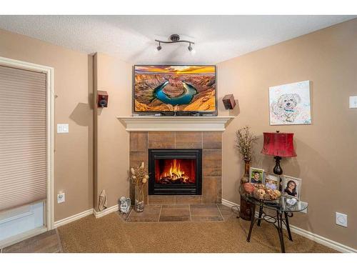 91 Gateway Mews South, Lethbridge, AB - Indoor Photo Showing Living Room With Fireplace