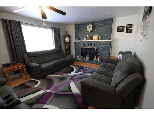 5320 43 Ave., Taber, AB - Indoor Photo Showing Living Room With Fireplace