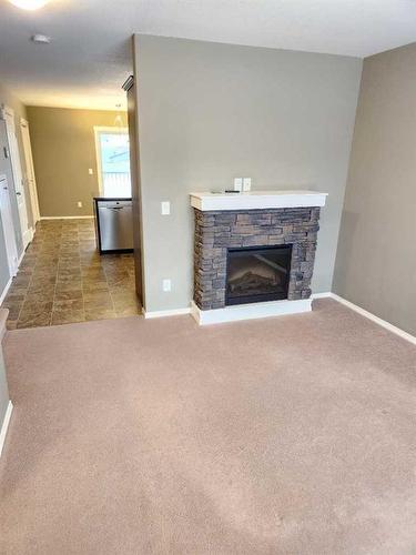 57-49 Keystone Terrace West, Lethbridge, AB - Indoor Photo Showing Living Room With Fireplace