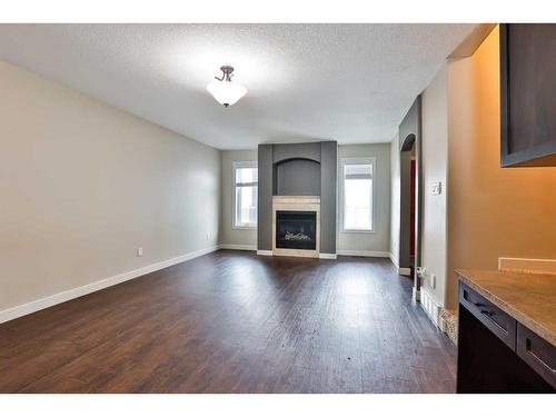 7-3814 Sundance Close, Coalhurst, AB - Indoor Photo Showing Living Room With Fireplace