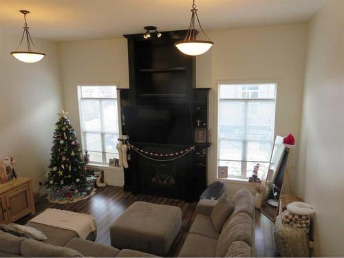 843 Mt Sundance Manor West, Lethbridge, AB - Indoor Photo Showing Living Room With Fireplace