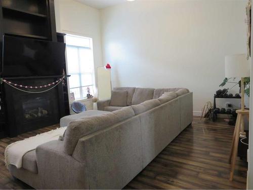 843 Mt Sundance Manor West, Lethbridge, AB - Indoor Photo Showing Living Room With Fireplace