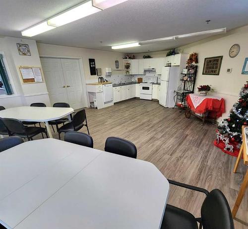 108-4800A 48 Avenue, Taber, AB - Indoor Photo Showing Other Room With Fireplace