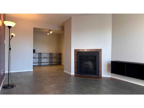 308-3910 23 Avenue South, Lethbridge, AB - Indoor Photo Showing Living Room With Fireplace