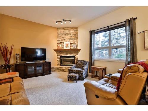 19 Coachwood Road West, Lethbridge, AB - Indoor Photo Showing Living Room With Fireplace