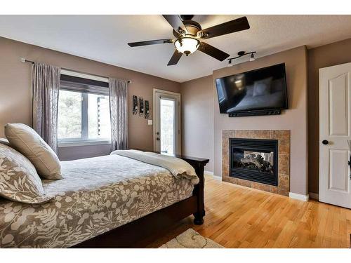 81 Salish Place West, Lethbridge, AB - Indoor Photo Showing Bedroom With Fireplace