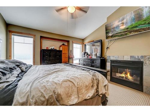 11 Ironstone Dr, Coleman, AB - Indoor Photo Showing Bedroom With Fireplace