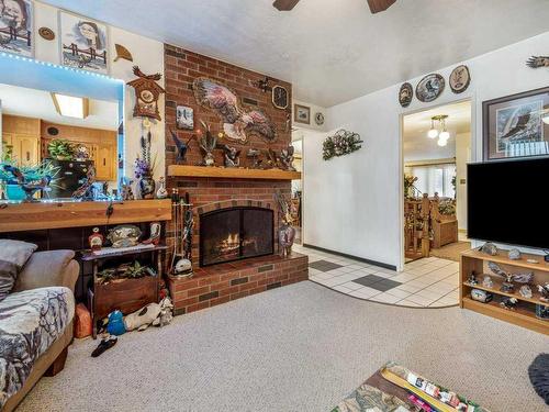 33 Nevada Road West, Lethbridge, AB - Indoor Photo Showing Living Room With Fireplace