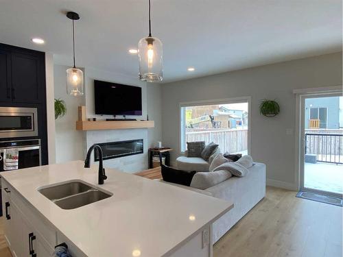 131 Goldenrod Road West, Lethbridge, AB - Indoor Photo Showing Kitchen With Fireplace With Double Sink