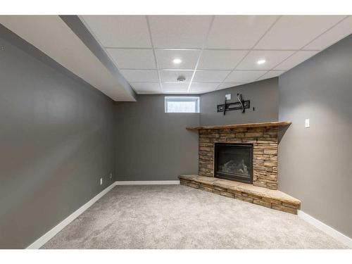 2114 16A Avenue, Coaldale, AB - Indoor Photo Showing Basement With Fireplace