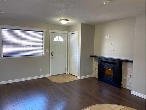 1415 Lakemount Boulevard South, Lethbridge, AB - Indoor Photo Showing Living Room With Fireplace