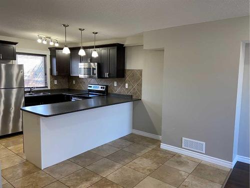 1415 Lakemount Boulevard South, Lethbridge, AB - Indoor Photo Showing Kitchen With Stainless Steel Kitchen With Double Sink