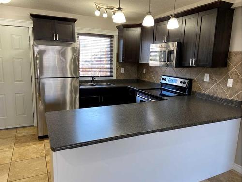 1415 Lakemount Boulevard South, Lethbridge, AB - Indoor Photo Showing Kitchen With Stainless Steel Kitchen With Double Sink