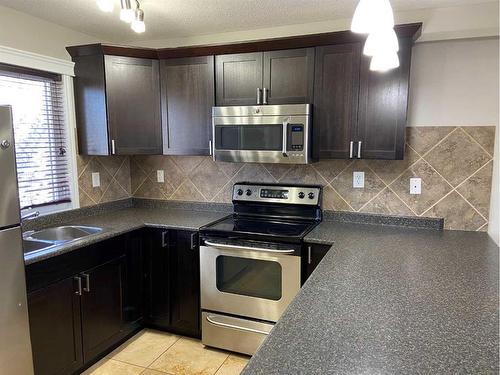 1415 Lakemount Boulevard South, Lethbridge, AB - Indoor Photo Showing Kitchen With Stainless Steel Kitchen With Double Sink