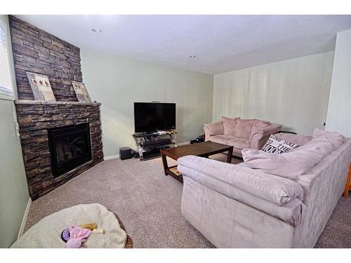 415 Haru Moriyama Place North, Lethbridge, AB - Indoor Photo Showing Living Room With Fireplace