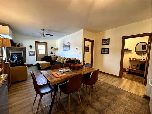 4-12331 20 Avenue, Blairmore, AB - Indoor Photo Showing Dining Room With Fireplace