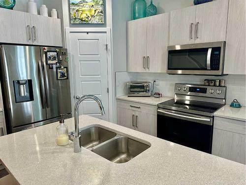 408-210 Firelight Way West, Lethbridge, AB - Indoor Photo Showing Kitchen With Stainless Steel Kitchen With Double Sink