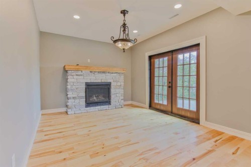 96S 100W, Raymond, AB - Indoor Photo Showing Living Room With Fireplace