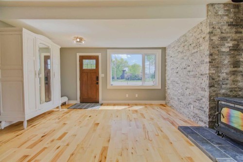 96S 100W, Raymond, AB - Indoor Photo Showing Other Room With Fireplace