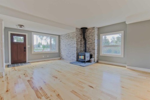 96S 100W, Raymond, AB - Indoor Photo Showing Other Room With Fireplace