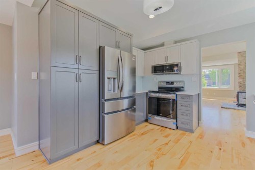 96S 100W, Raymond, AB - Indoor Photo Showing Kitchen With Stainless Steel Kitchen