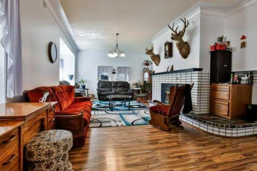 5202 52 Street, Taber, AB - Indoor Photo Showing Living Room With Fireplace