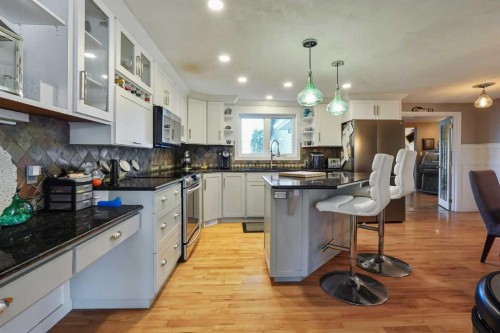 121S 100W, Raymond, AB - Indoor Photo Showing Kitchen With Stainless Steel Kitchen With Upgraded Kitchen